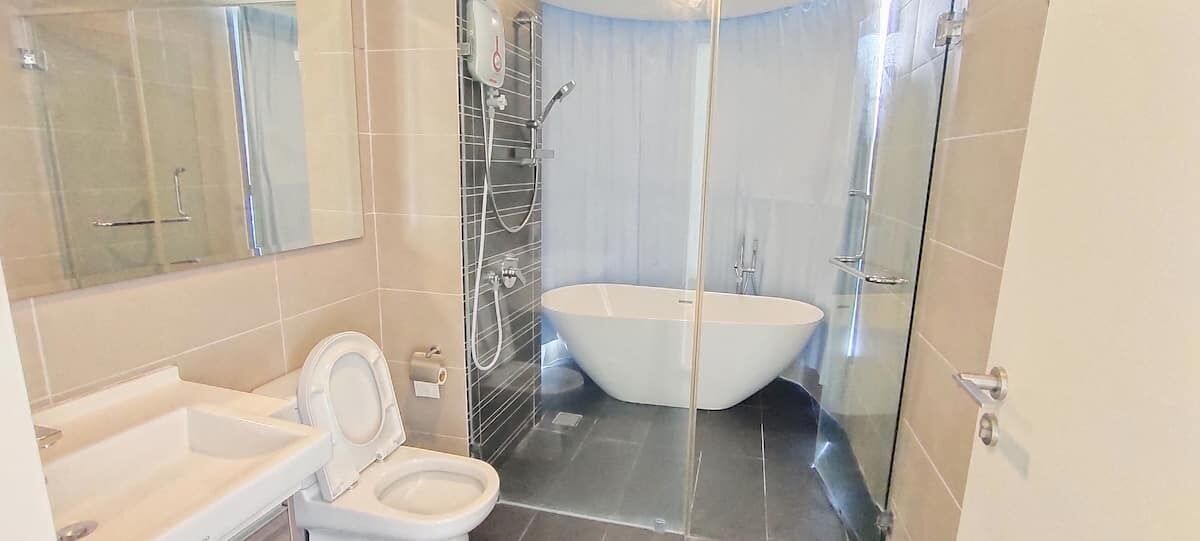A bathroom with a bathtub, toilet, and shower.