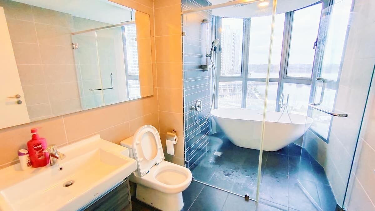 A bathroom with a bathtub, a toilet, and a sink.