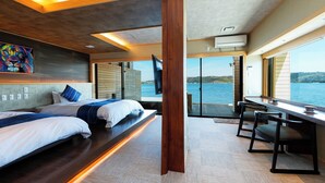 A modern room with two beds, a desk, and a large window overlooking a body of water. - Sennentei (Yurihama)