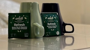 Two green tea and cinnamon boxes labeled 'amati ayurveda' on a reflective surface. - Charming apartment in Arras for a cozy getaway (Arras)