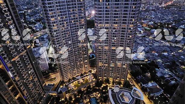 Un complejo residencial de edificios de gran altura con varias torres, un patio central de diseño circular y edificios más pequeños alrededor.