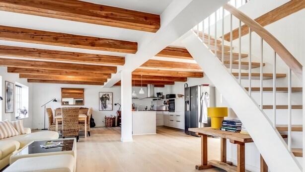 A spacious living area with a high ceiling, wooden beams, a staircase, and a kitchen in the background. - "Albine" - 150m from the sea by Interhome (Skagen)