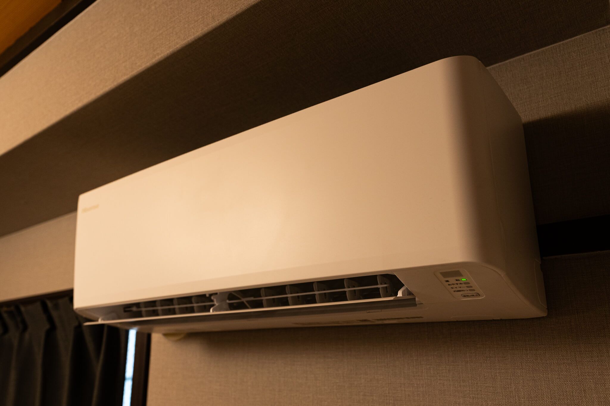 A white air conditioning unit mounted on a wall.