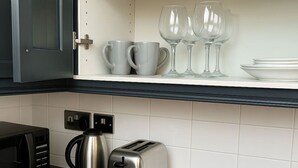 A kitchen with a toaster, a kettle, and a microwave on the counter. - Apt 4,34 Wood street (Liverpool)