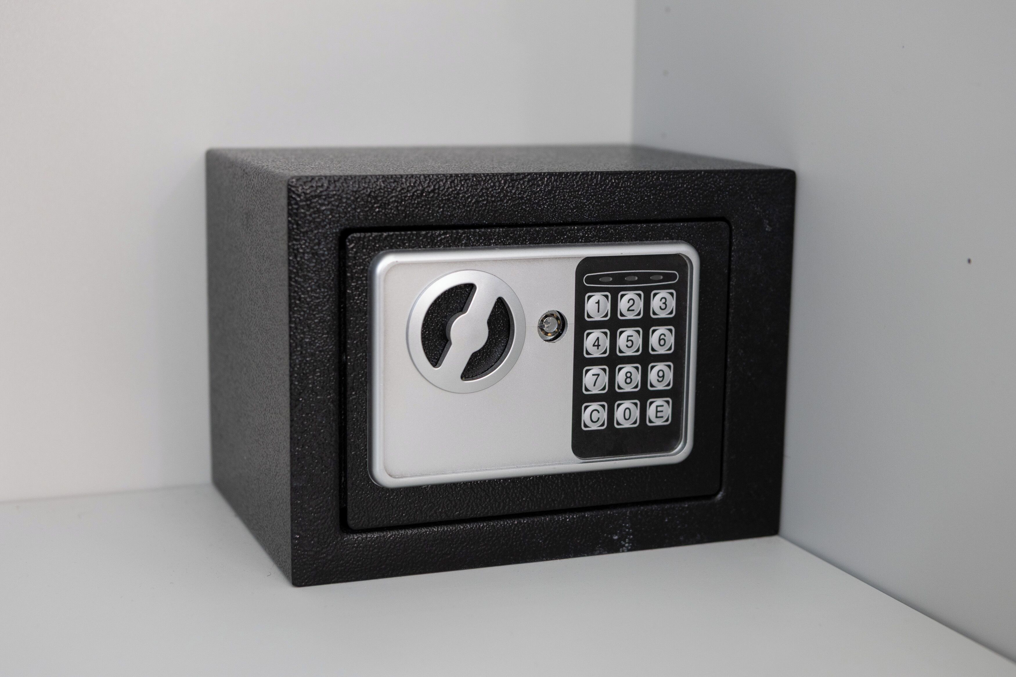 A black safe with a keypad and a circular lock mechanism.