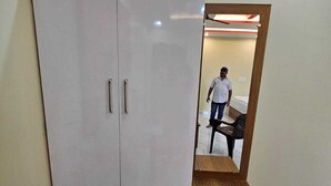 Un armario grande con dos puertas y un banco de madera.