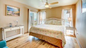A bedroom with a bed, a desk, a ceiling fan, and a window with curtains. - Enjoy oceanfront views from this 2BR condo at Topsail Dunes 3308 in North Topsail Beach. (North Topsail Beach)