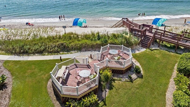 A beachside property with a deck area featuring outdoor furniture and a view of the ocean. - Enjoy oceanfront views from this 2BR condo at Topsail Dunes 3308 in North Topsail Beach. (North Topsail Beach)