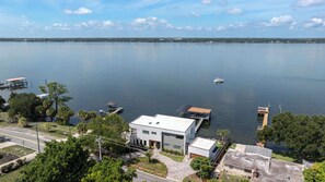 A waterfront property with a modern house, dock, and boat.