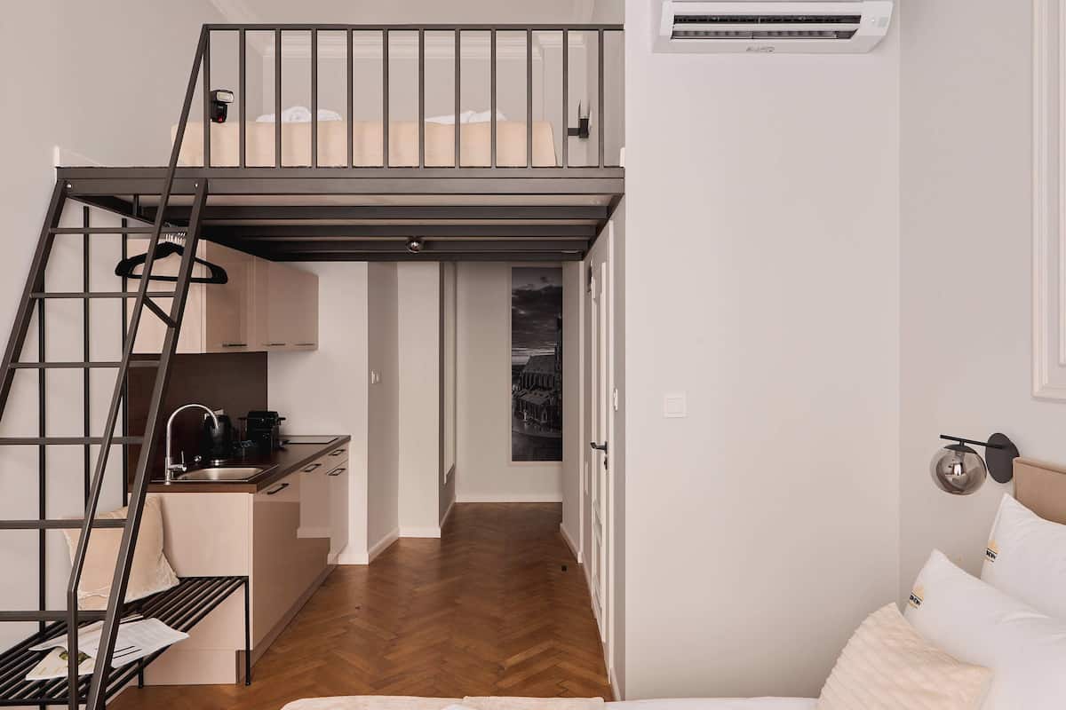 Deluxe Studio Suite | Living area | 35-inch flat-screen TV with cable channels