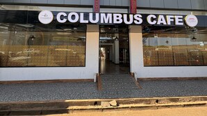 The Columbus Cafe building with a prominent sign, large windows, and a tiled entrance area. - Columbus Hotel Eldoret (Eldoret)