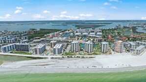 A coastal resort area with multiple high-rise buildings, a beach, and a marina.