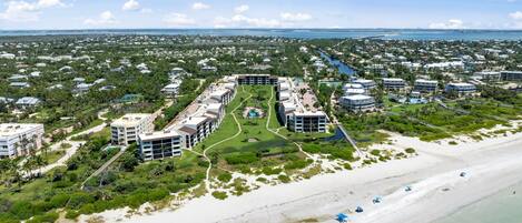 A coastal resort with multiple buildings, a beachfront, and a marina.
