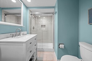 A bathroom with a white sink, a glass-enclosed shower, and a toilet. - Loggerhead Cay 302 w Bikes Pool on Beach (Sanibel)