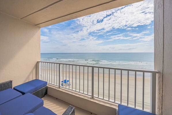 A balcony with a view of the beach, featuring a railing and seating area. - #402 Southpoint 2/2 Oceanfront Traffic Free Beach (Ponce Inlet)