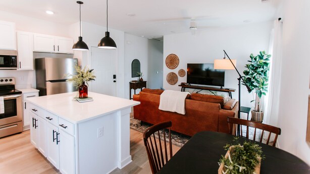 A modern kitchen with white cabinetry, a stainless steel refrigerator, and a central island. - Mid-Term Discounts - Near Downtown, UGA, Hospital (Athens)