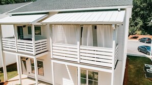 A two-story building with balconies, a garage, and a parking area. - Mid-Term Discounts - Near Downtown, UGA, Hospital (Athens)