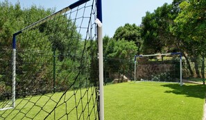 A soccer goal with a net, surrounded by a green field and trees. - Modern new Villa with 4 bedrooms and sea views. With private Pool (2026) (Sassari)