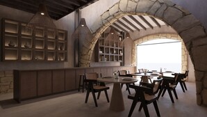 A restaurant with stone arches, wooden furniture, and hanging lights. - Enliven Lifestyle Hotel Nicosia (Nicosia)