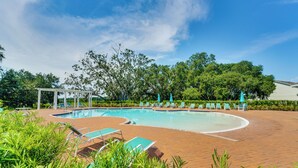 A swimming pool with lounge chairs and umbrellas, surrounded by greenery and a pergola. - Pool Access: Family Gem w/ Views in St Cloud! (St. Cloud)