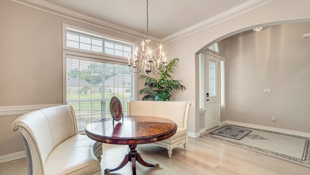 A dining area with a round table, two chairs, a chandelier, and a potted plant. - 8 Mi to Lake Palestine: Peaceful Family Retreat (Flint)