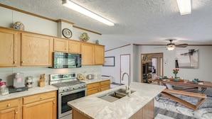 A modern kitchen with wooden cabinets, stainless steel appliances, and a marble countertop. - 1 Mi to Geneva SP: Family Home w/ Game Room & Yard (Geneva)
