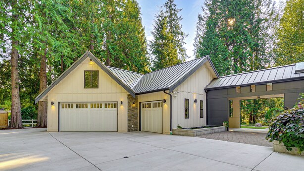 A two-story house with a garage, a covered porch, and a stone foundation. - Wfh-friendly Gem w/ Creek: 4 Mi to Sammamish Trail (Redmond)