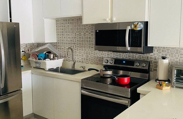 A modern kitchen with stainless steel appliances, a microwave, and a toaster. - 1 Bedroom Mountain Retreat New Kingston (Kingston)