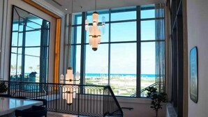 A spacious room with large windows offering a view of the beach. - Deluxe 1-BR Sea view Address Beach Marassi (El Alamein)