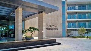 A modern building with a sign reading "VIDA MARINA RESORT MARASSI".