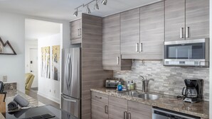 A modern kitchen with stainless steel appliances, a microwave, and a coffee maker. - Smuggler Mine — Modern Pet-Friendly Retreat Near Slopes (Telluride)