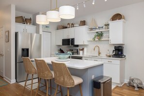 Fridge, dishwasher, coffee/tea maker, cookware/dishes/utensils