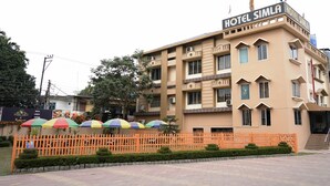 A multi-story hotel with balconies and a sign reading "HOTEL SIMLA". - HOTEL SIMLA (Siliguri)