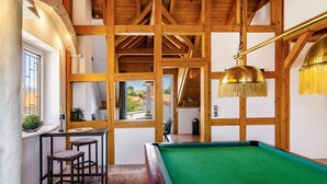 A pool table with balls, wooden beams, a window, and a bar area. - Apartment 'Männerleben' with Private Terrace and Wi-Fi (Harztor)