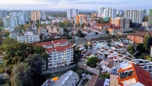 A cityscape with a mix of residential and commercial buildings, including high-rise apartments and smaller houses. - 2 Bedroom Duplex Apartment in Nairobi (Nairobi)