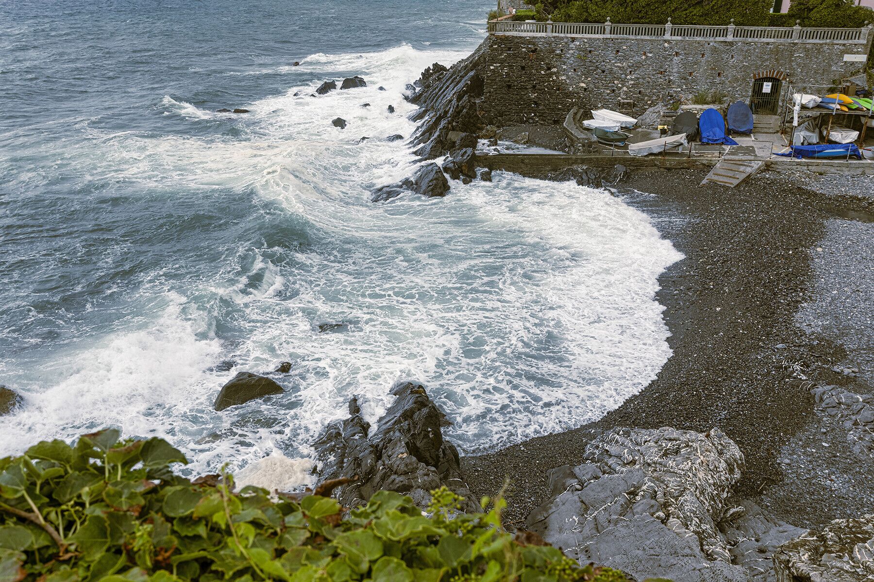 A rocky shoreline with waves crashing onto the beach.