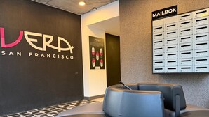 A modern interior with a leather seating area, a wall-mounted mailbox, and a sign for LERDA San Francisco.