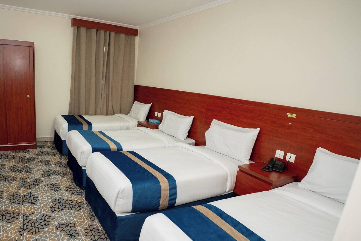 Comfort Quadruple Room, City View | In-room safe, desk, laptop workspace, blackout drapes