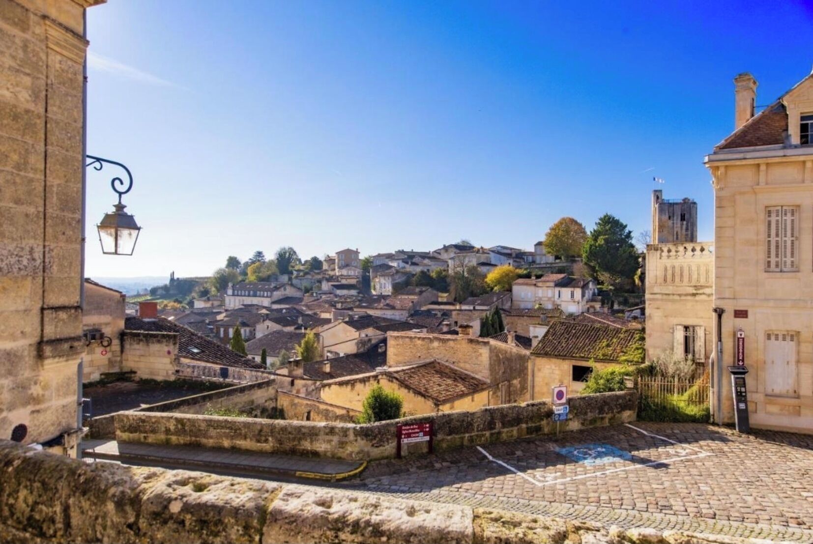 Una città storica con edifici in pietra, strade acciottolate e un'imponente torre.