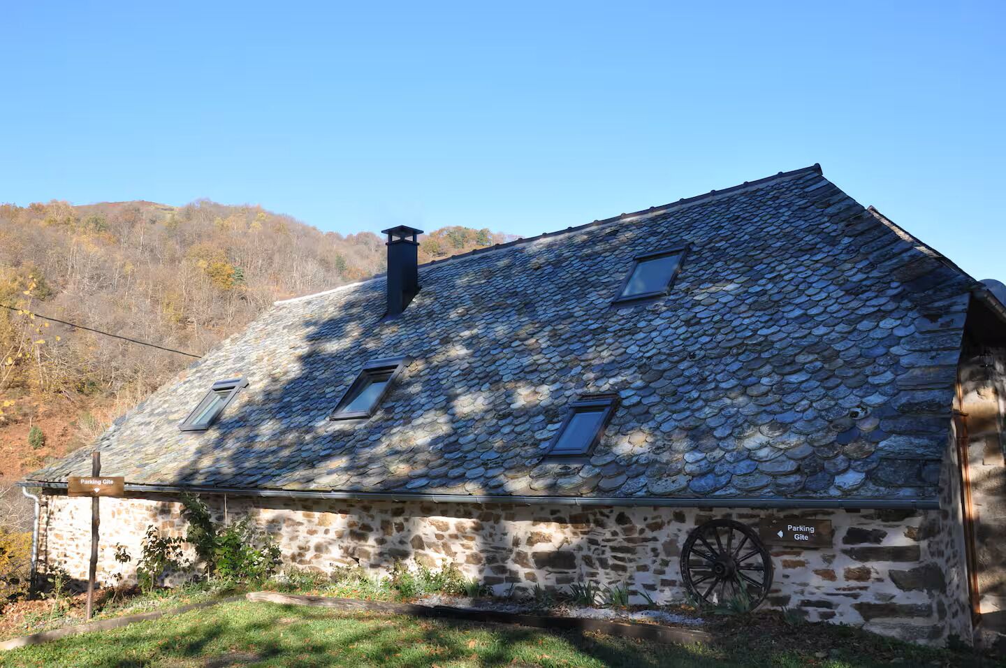 Un bâtiment en pierre doté d’un toit en pente et de nombreuses fenêtres.