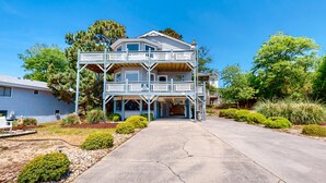 A two-story building with a balcony and a covered porch. - 4BR Soundview | Deck | Washer/Dryer (Duck)