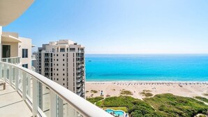 A high-rise hotel with a balcony overlooking a beach and ocean. - Stunning Oceanfront Penthouse at the Ritz-Carlton on Singer Island (Riviera Beach)