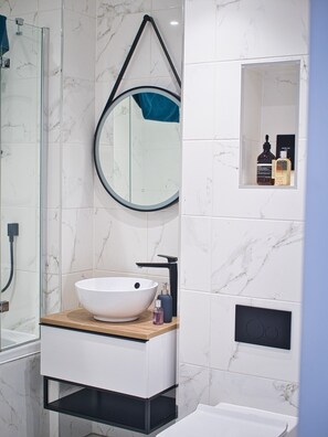 Shower, hair dryer, towels, toilet paper
