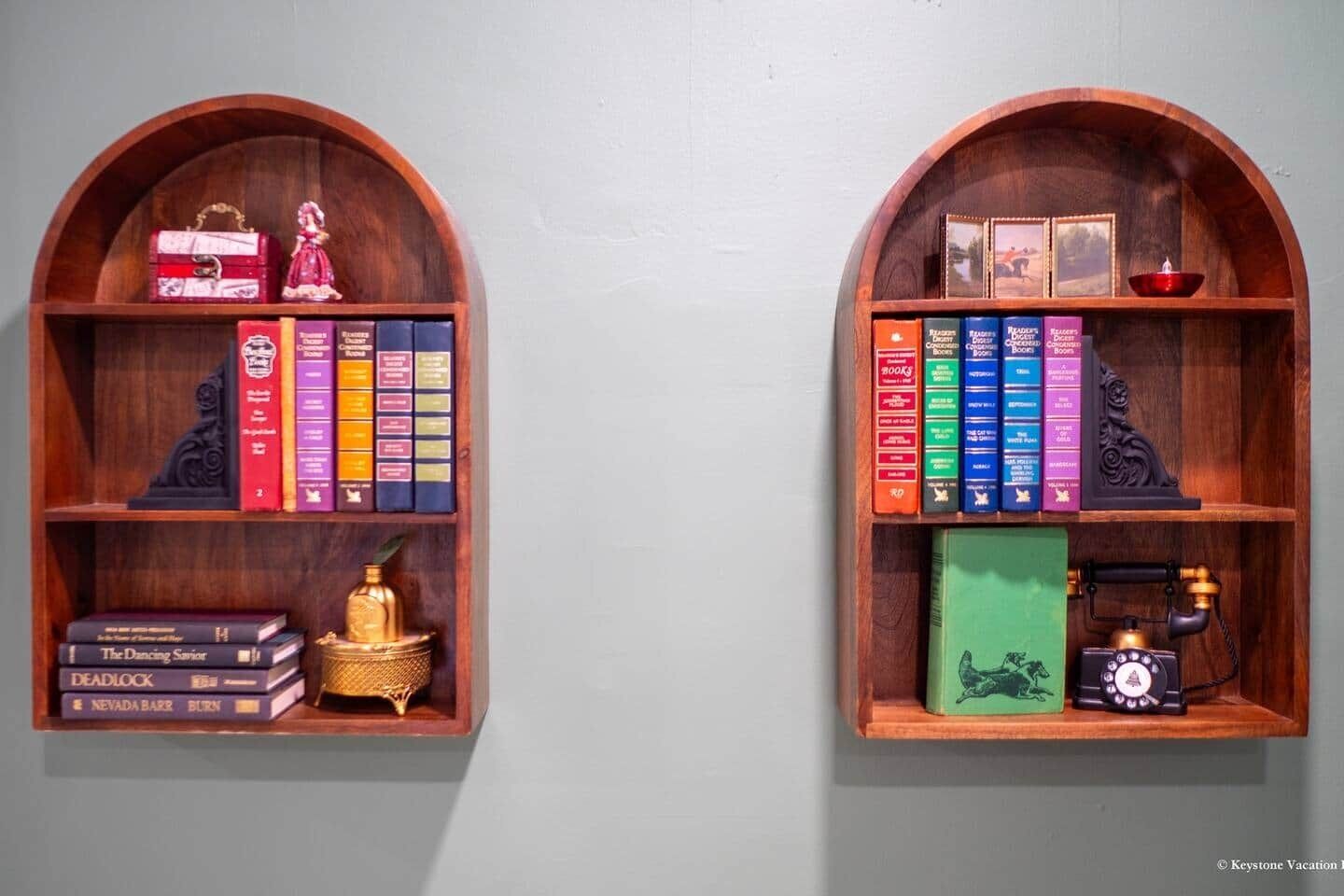 Two wooden bookshelves with books and decorative items.