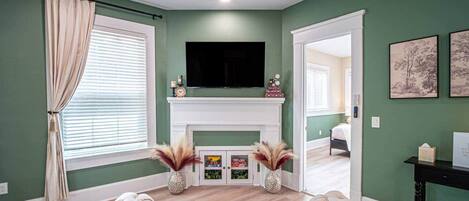A living room with a fireplace, a sofa, and a television.