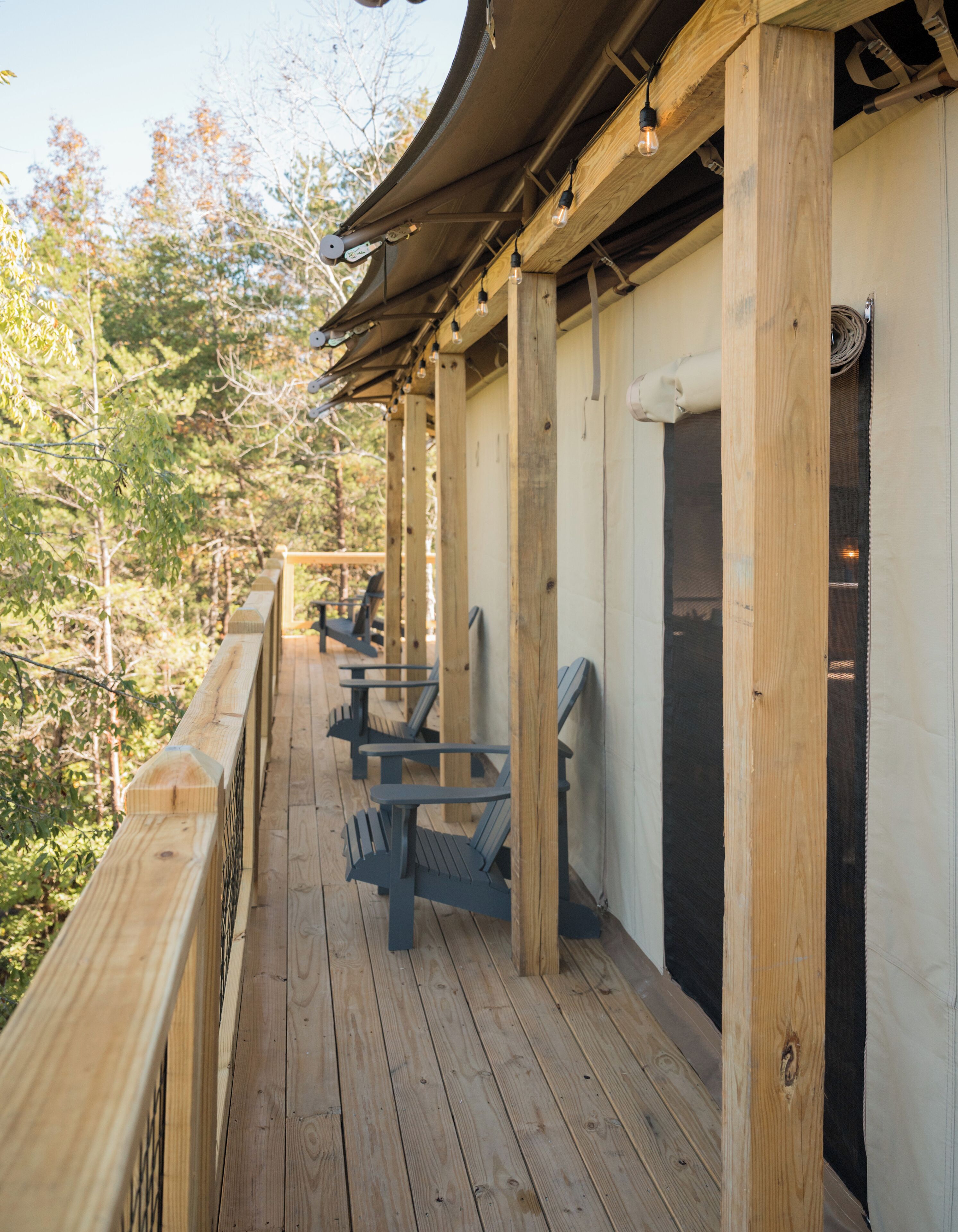 Une terrasse en bois avec des sièges extérieurs et un espace abrité.
