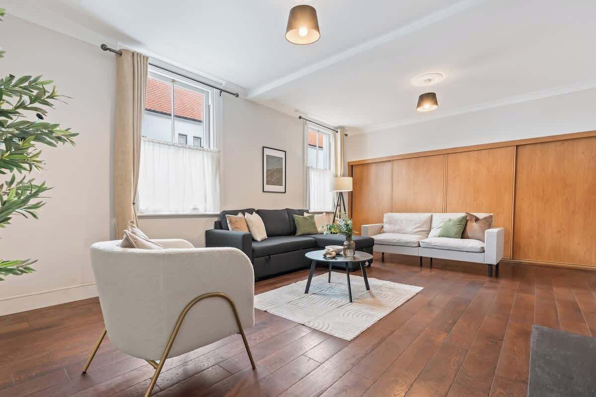 Spacious comfort awaits! With sofas, a cozy fireplace, and plenty of room to gather, this living room is perfect for movie nights, relaxed hangouts, or simply unwinding in style.
