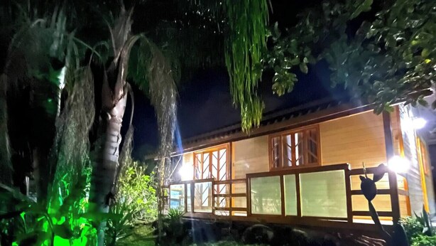 A two-story building with a wooden facade and large windows. - Country House with Waterfall and Pool - Maciambu Waterfall - Country House (Enseada de Brito)