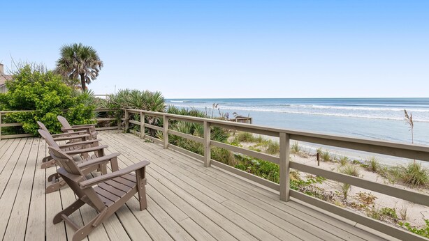 A wooden deck with chairs overlooking a beach. - Sea Dunes Green Turtle A3 (New Smyrna Beach)
