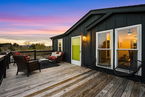 A deck with outdoor furniture, a door, and windows. - Little Haven Cottage: Walk to Meade Tasting (Afton)